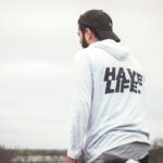 man in white and black hoodie and black cap