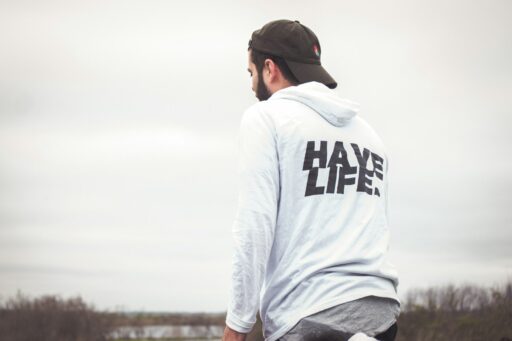 man in white and black hoodie and black cap