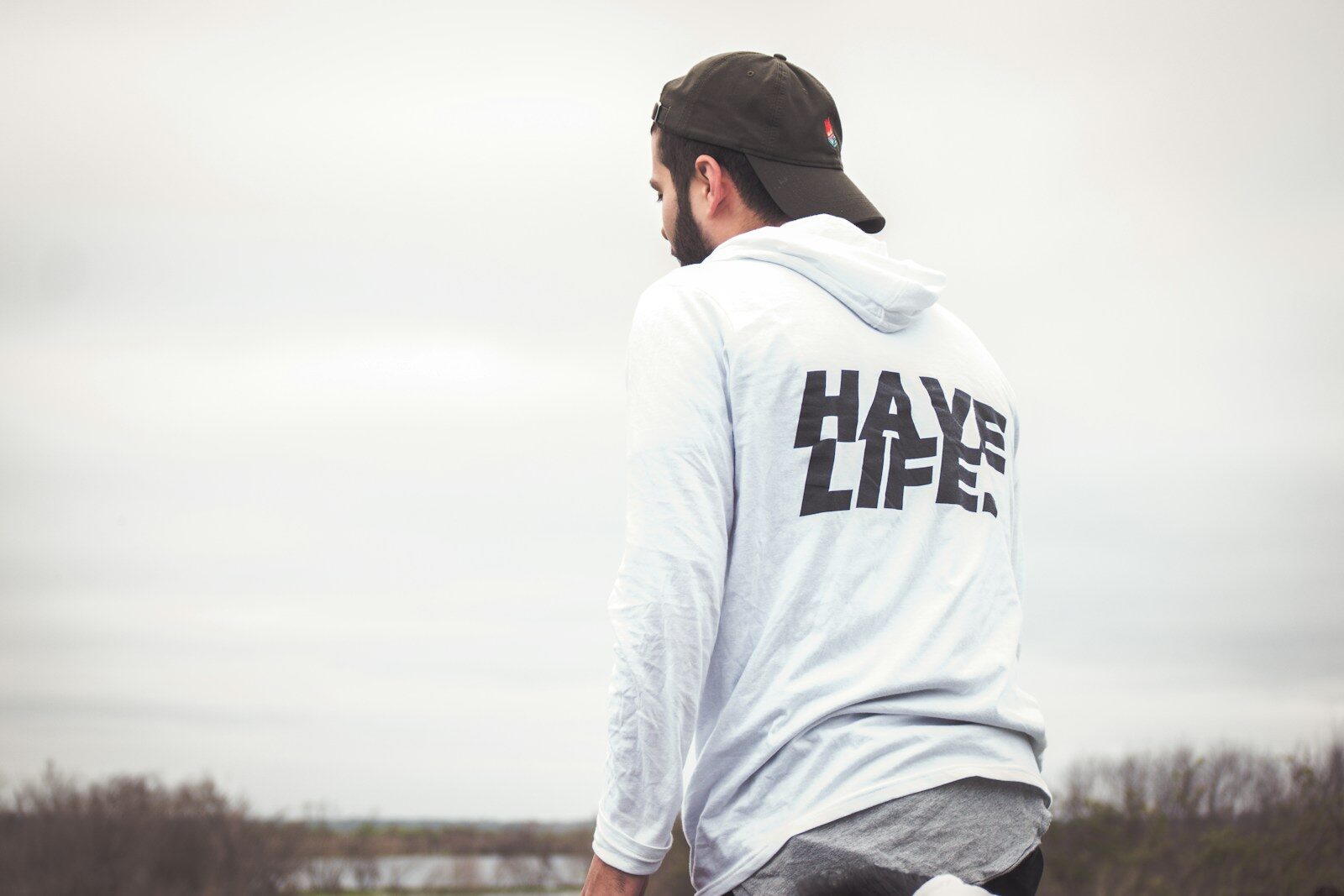 man in white and black hoodie and black cap
